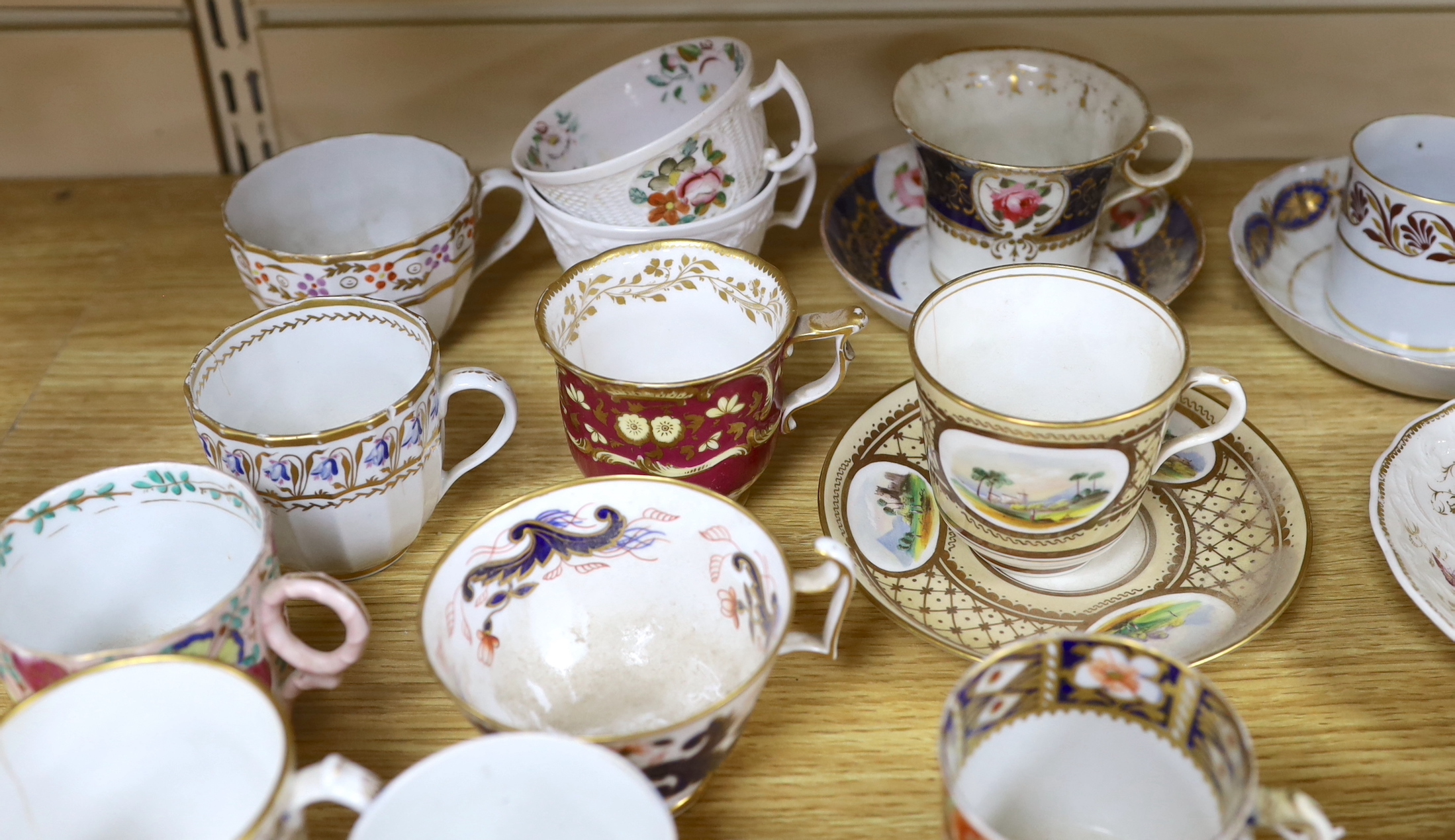 A collection of 18th and 19th century English and continental tea and coffee cups some with saucers, including a Worcester Queen Charlotte pattern coffee cup and saucer